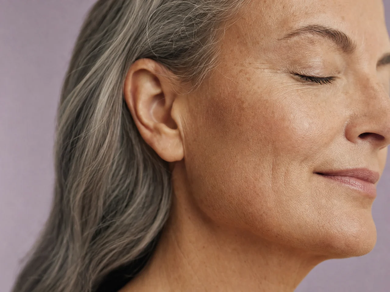 Soft side light revealing the natural texture of an adult cheek and jawline.